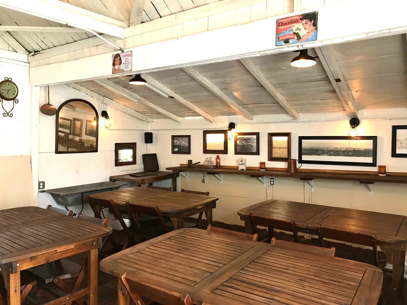 Contemporary Jennings House interior photograph with wood tables, painted beams and framed pictures